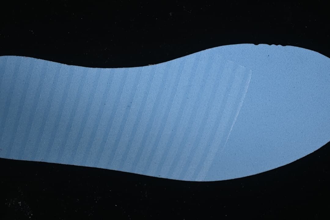 Blue shoe outsole or insert shown against a dark background