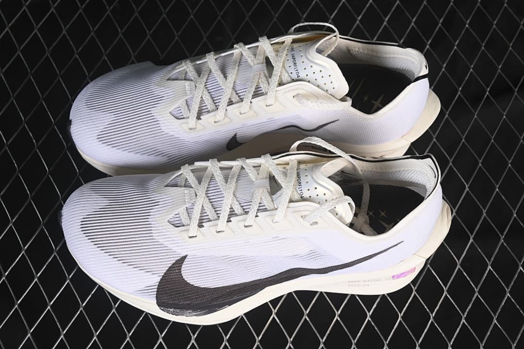 Pair of white and black Nike road racing shoes shown from above and the side