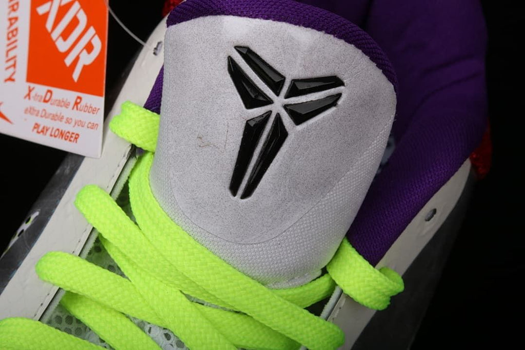 Close-up of the Kobe logo on the tongue and neon yellow-green laces