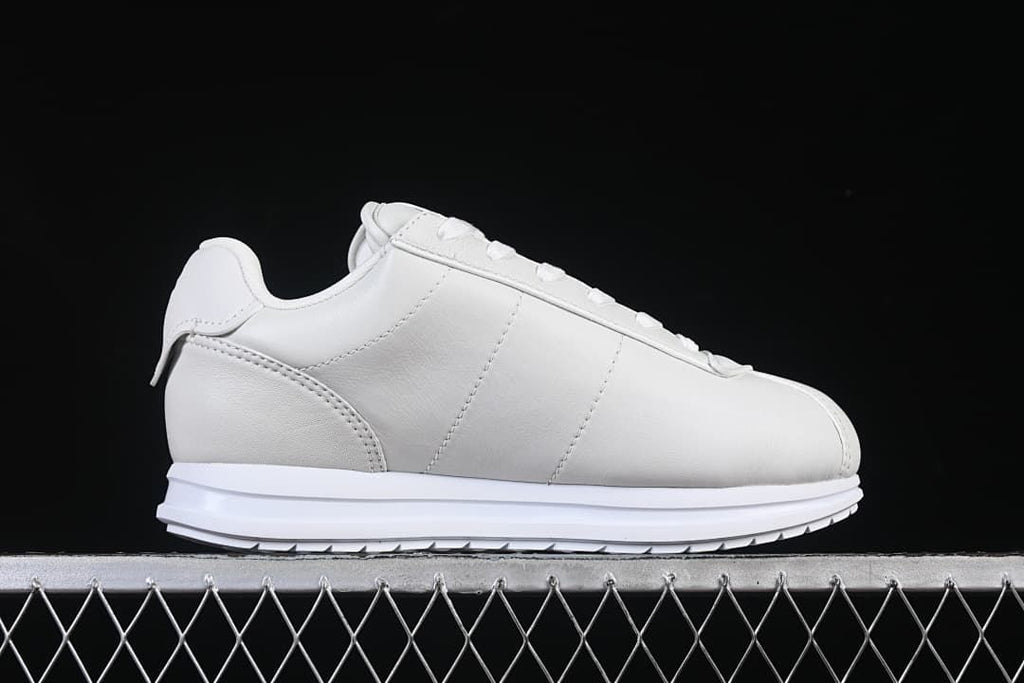 Side profile showing the sneaker's smooth panels and low-top shape