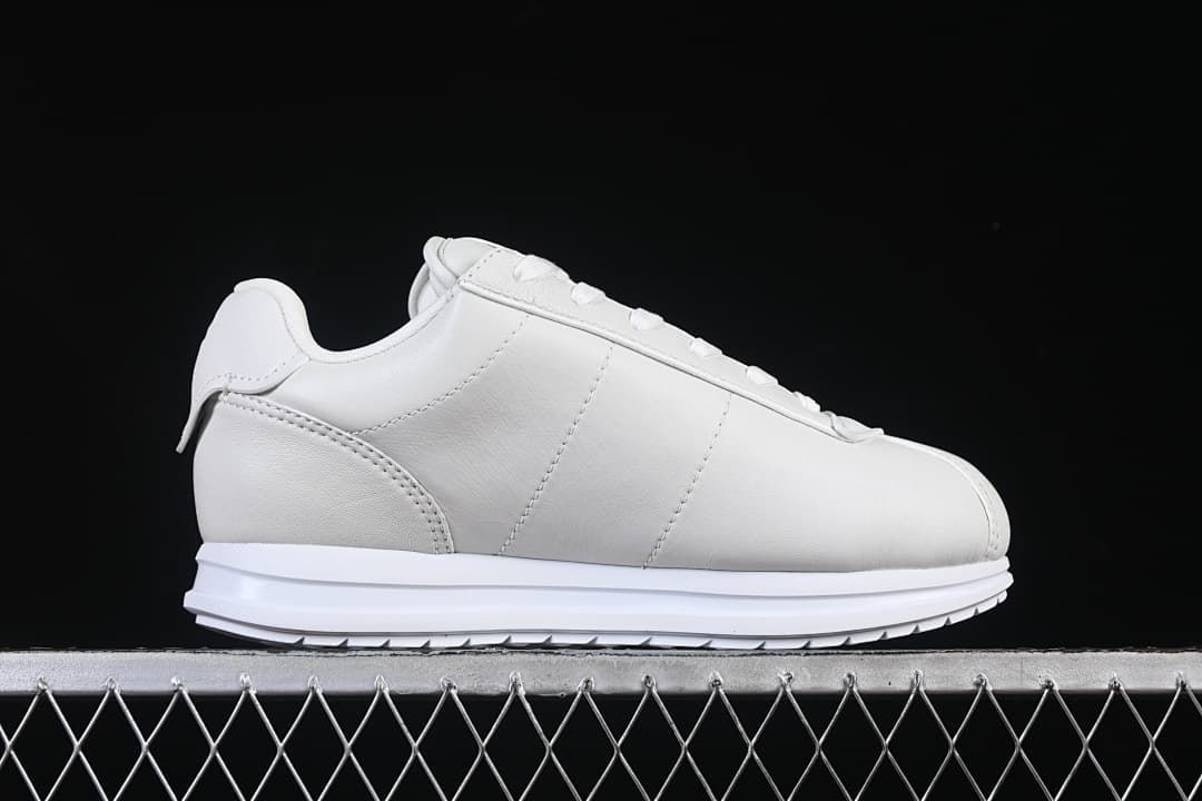 Side profile showing the sneaker's smooth panels and low-top shape