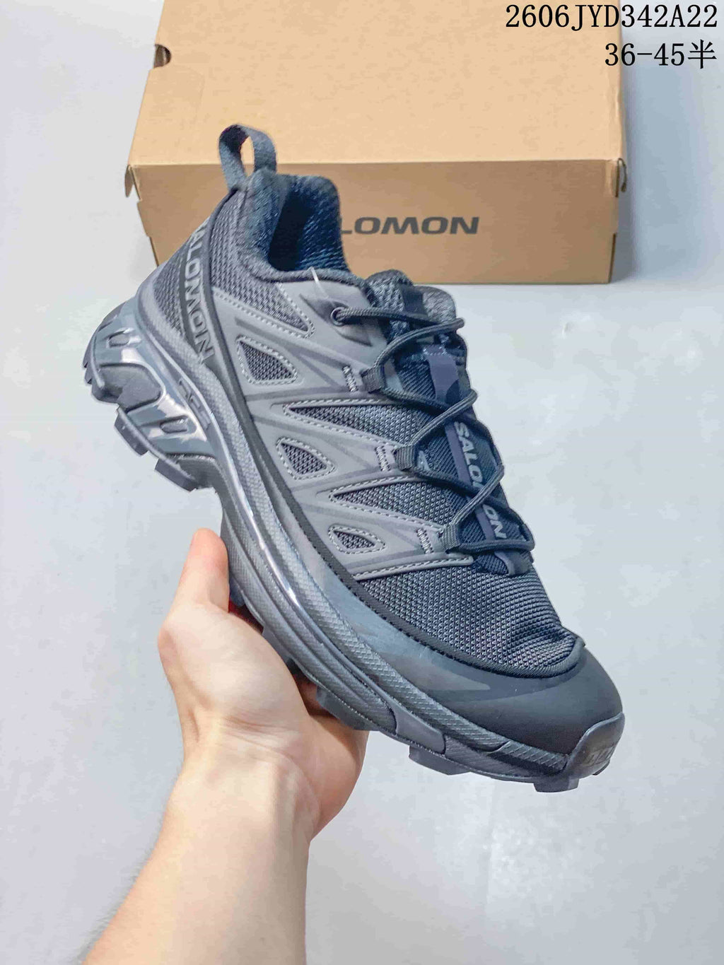 Dark gray Salomon mesh sneaker with a rugged-looking outsole, side view