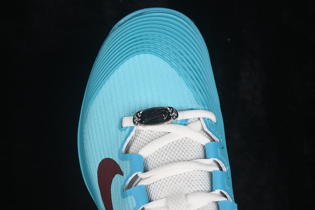 Top view of the aqua toe box, white laces and burgundy side detail.