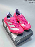 Pair of pink Adidas Adizero running shoes with white side stripes on a shoebox.