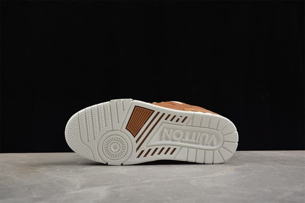 Underside view of the white sneaker outsole with brown accent sections.