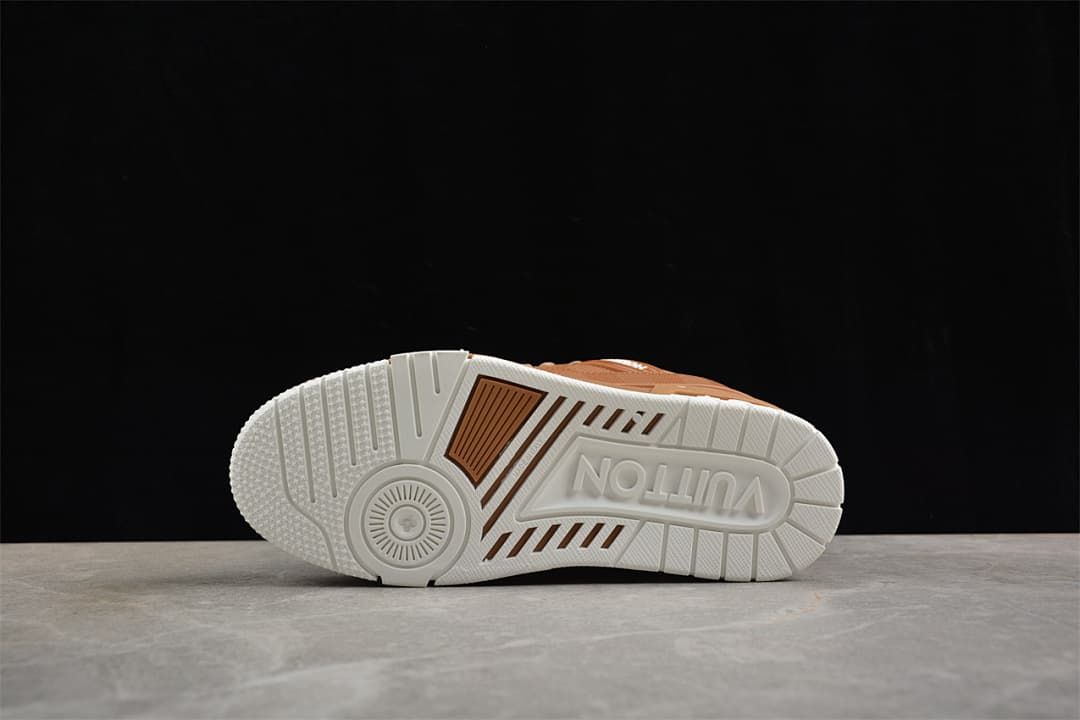 Underside view of the white sneaker outsole with brown accent sections.