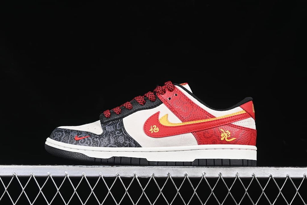 Side view of a low-top sneaker with red, black, off-white, and yellow panels and patterned overlays