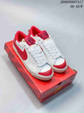 White and red Nike Court Royale AC sneakers shown from above on a red shoe box.