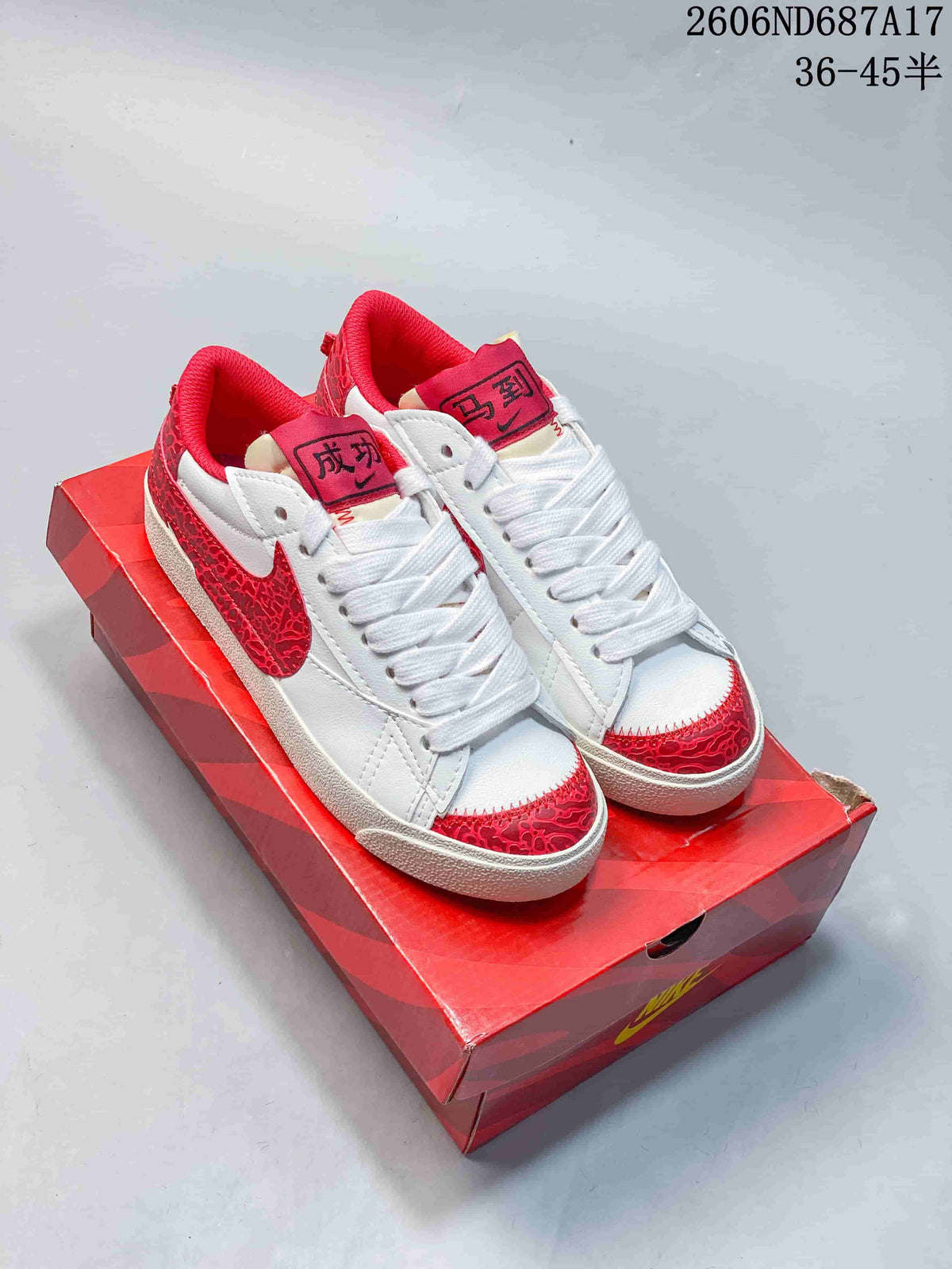 White and red Nike Court Royale AC sneakers shown from above on a red shoe box.