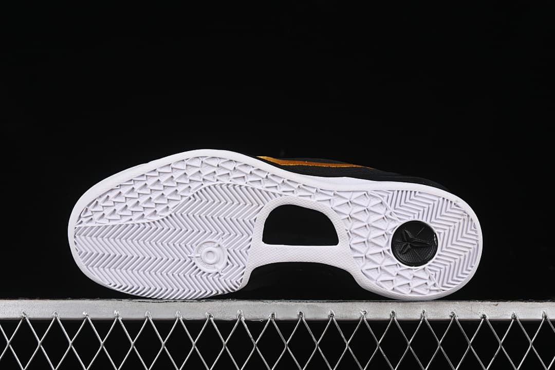 Underside view showing white patterned outsole and a black circular insert