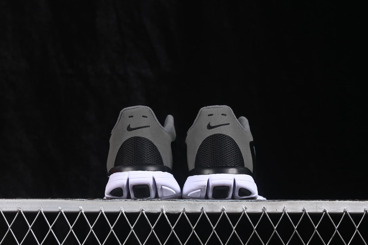 Rear view of the pair showing grey heel panels, black heel mesh and white segmented outsoles.