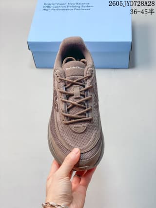 Top view of a taupe-brown New Balance running shoe with mesh upper and laces