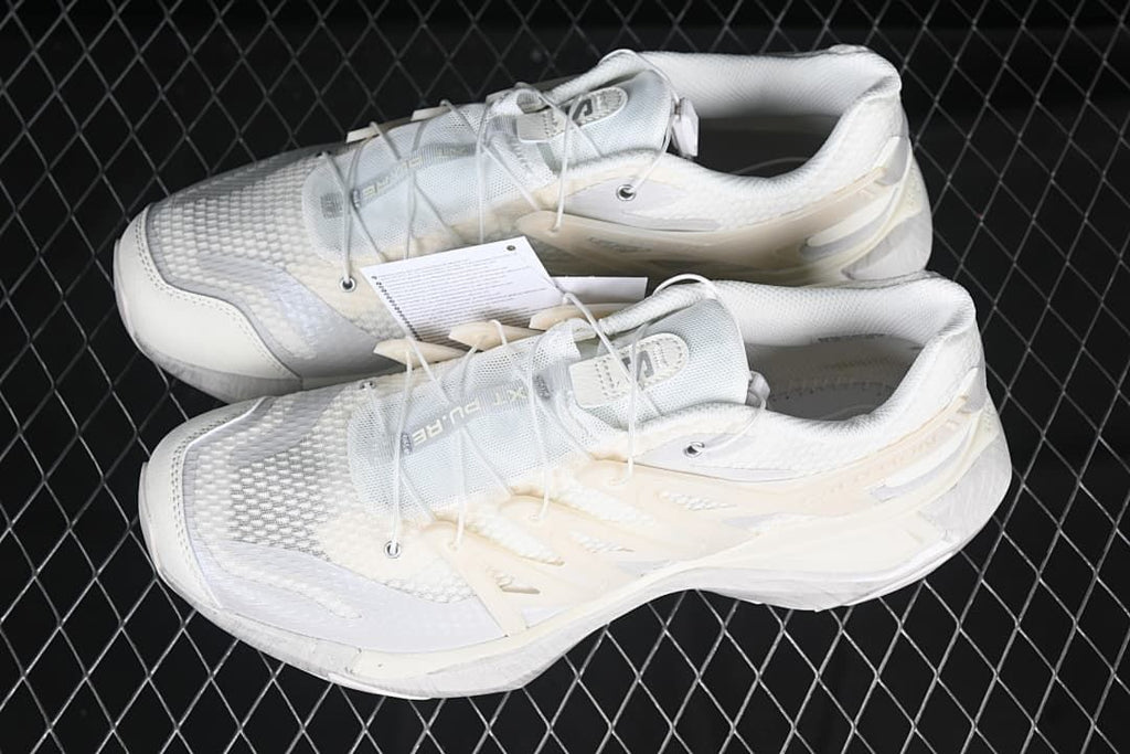 Pair of white trail running shoes shown from above