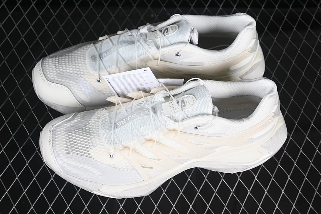 Pair of white trail running shoes shown from above