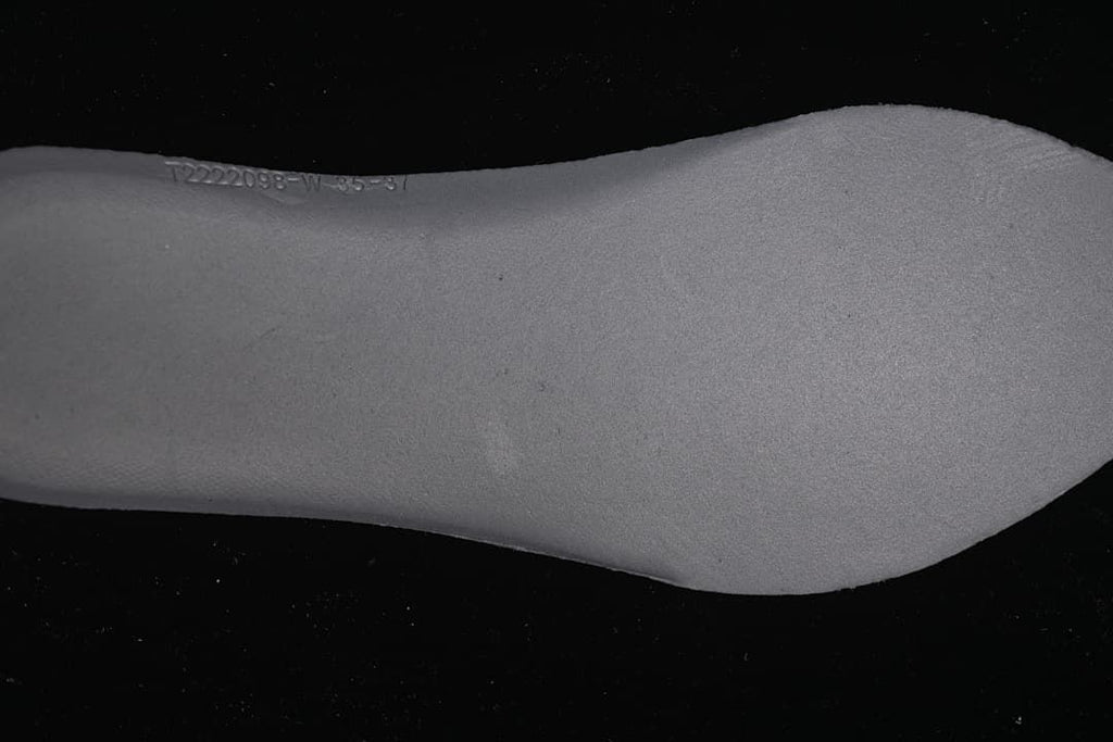 Close-up of the shoe insole with a faint printed marking