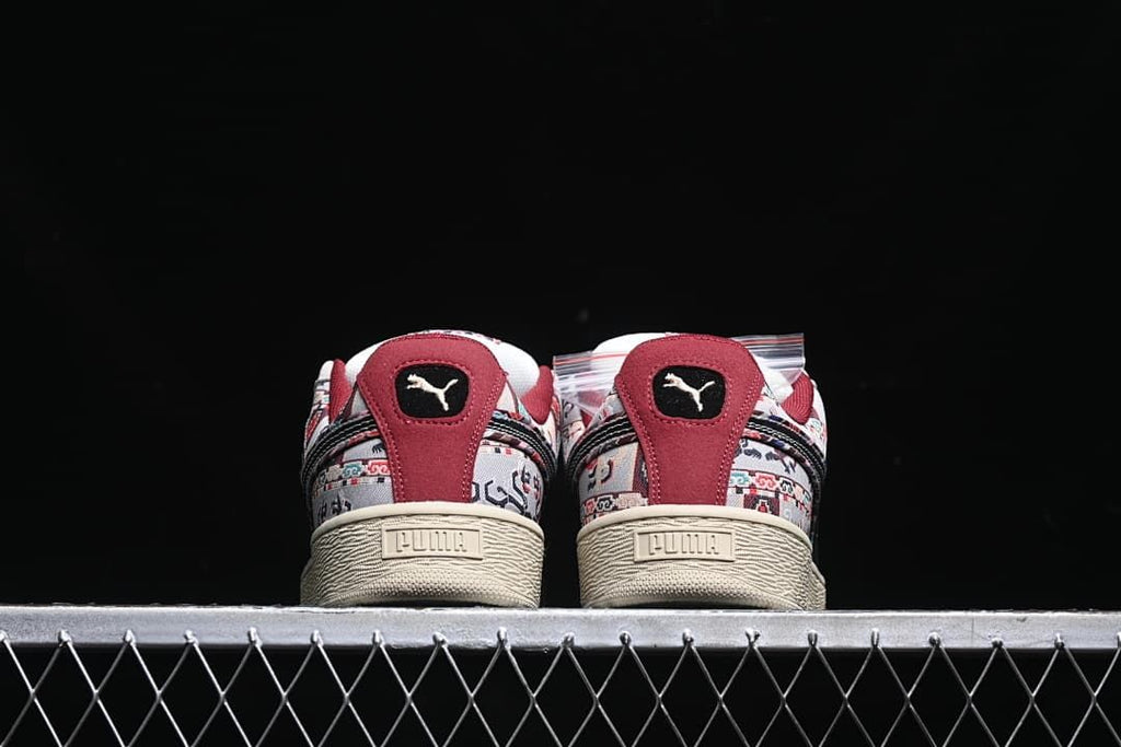 Rear view of the pair showing burgundy heel panels and textured cream soles