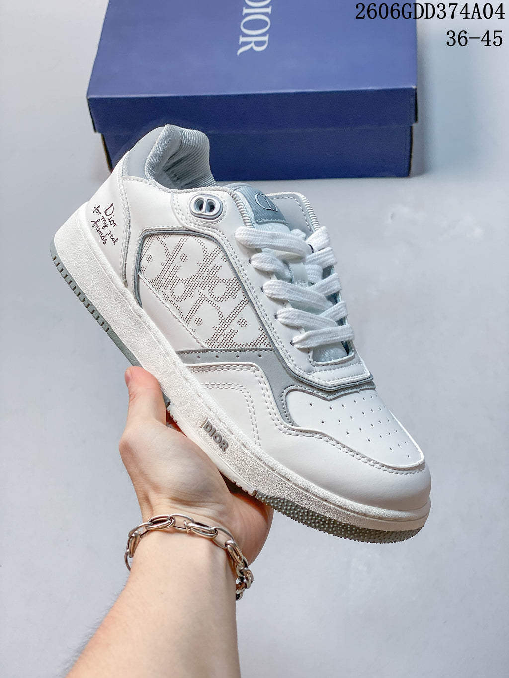 Angled side view of the white and gray sneaker with patterned side panels