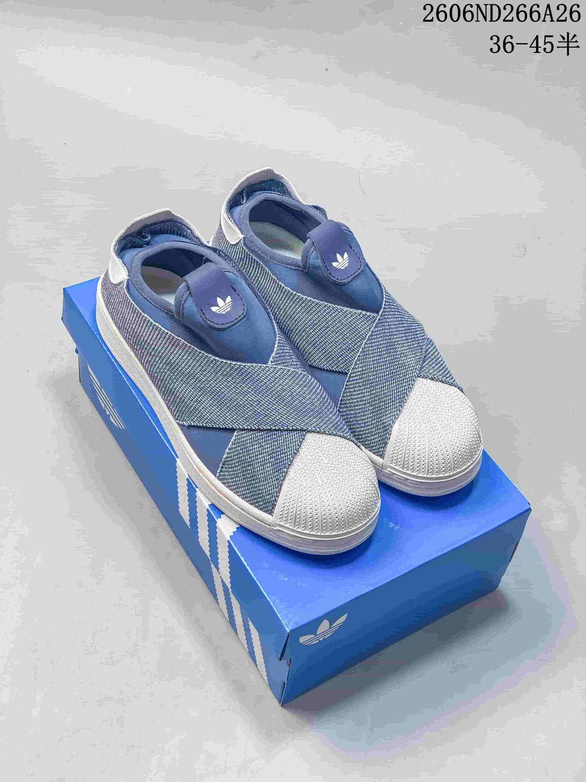 Pair of blue adidas Originals Superstar 2 slip-on sneakers with white shell-style toe caps.