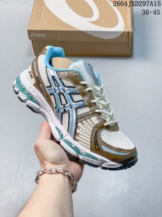 ASICS low-top sneaker with blue and beige accents, layered panels, and a contrasting outsole.