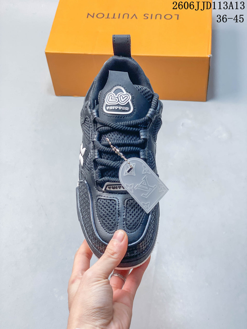 Top view of the dark navy lace-up sneaker with mesh sections and a decorative hangtag.