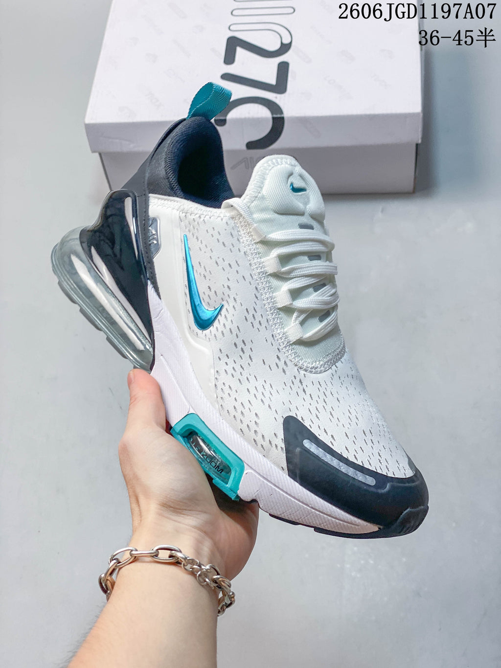 Side view of the Nike Air Max Pulse with white upper, teal Swoosh, and dark heel detail