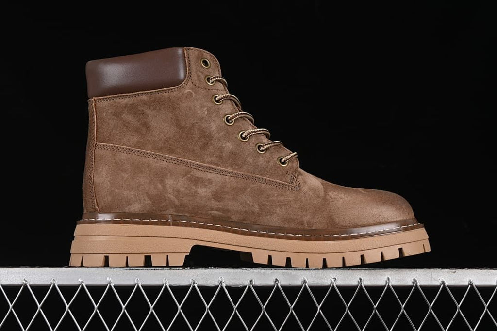 Side profile of a single khaki-brown boot