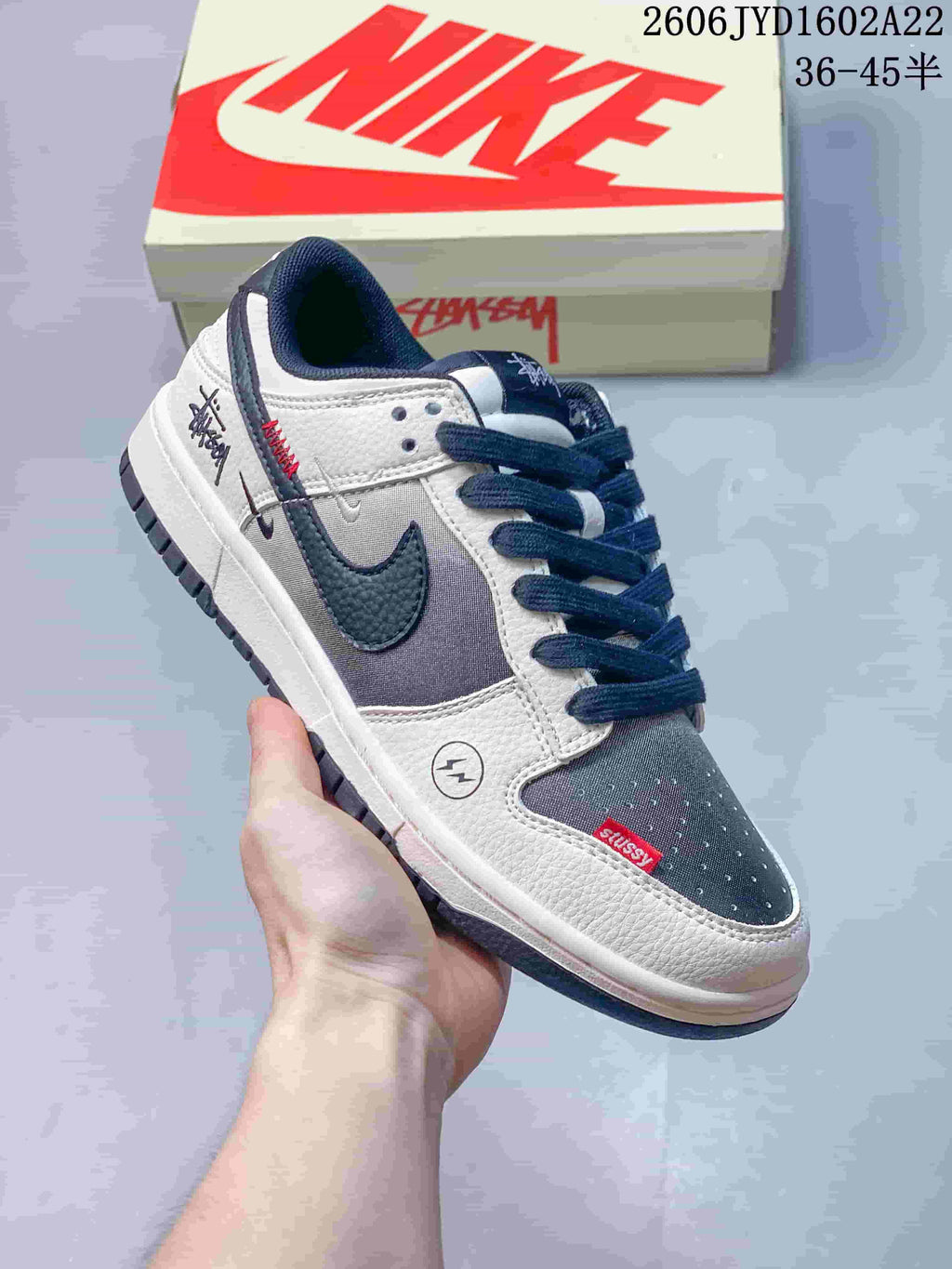 White and gray low-top sneaker with dark blue accents and red details
