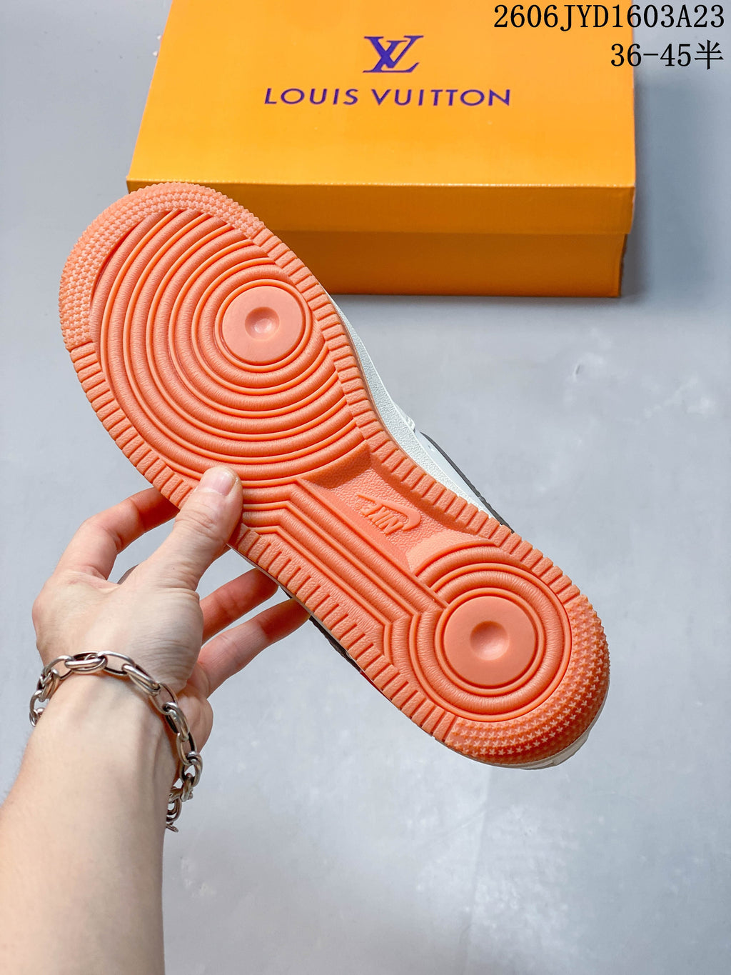 Close-up of the orange-colored tread outsole on the sneaker