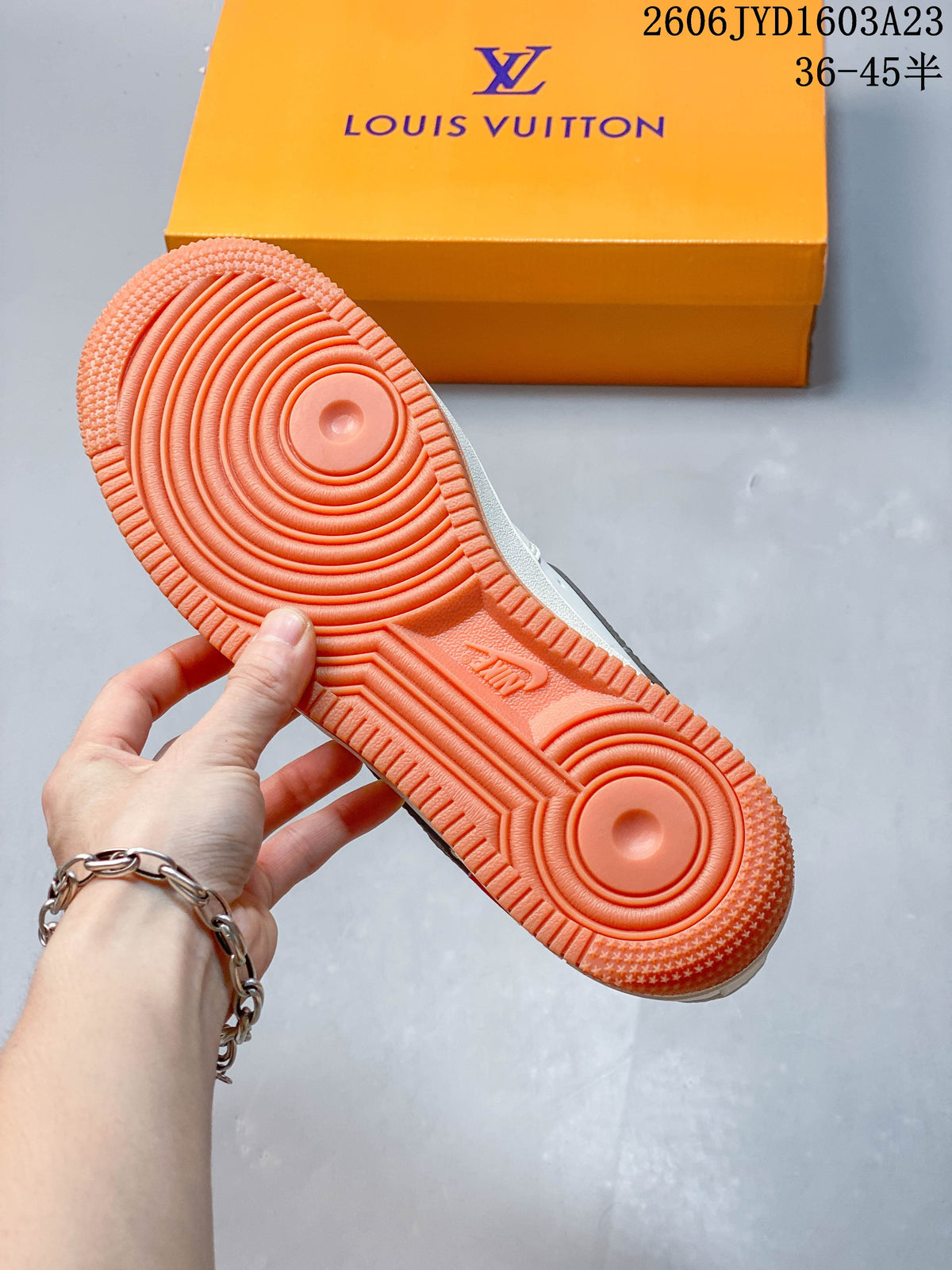 Close-up of the orange-colored tread outsole on the sneaker