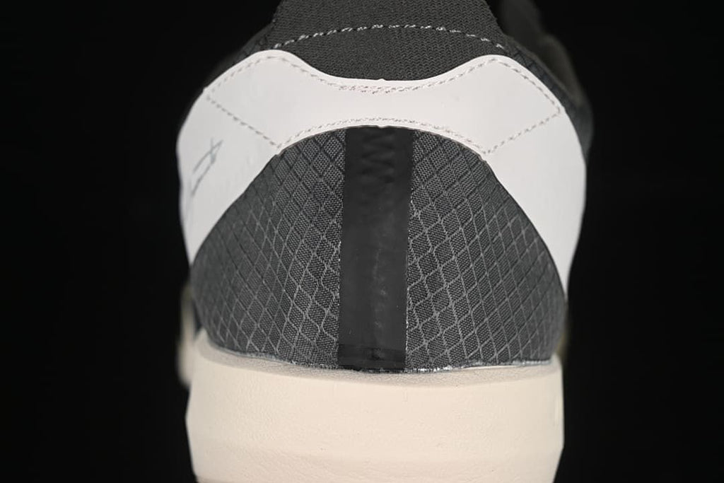 Rear view of the shoe with light-colored heel overlay