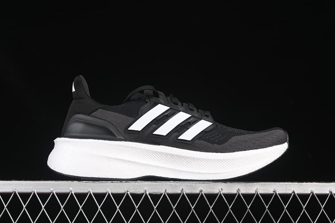 Side profile of a black and grey Adidas Ultraboost 5 with white stripes and midsole