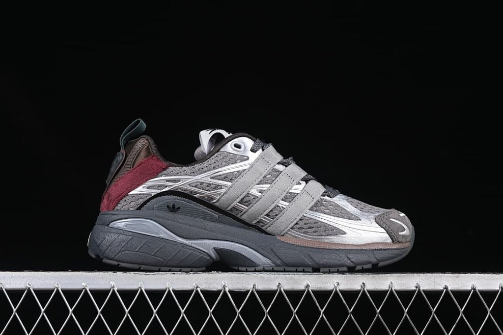 Side profile of one adidas Adistar Cushion sneaker in gray, silver, and burgundy.