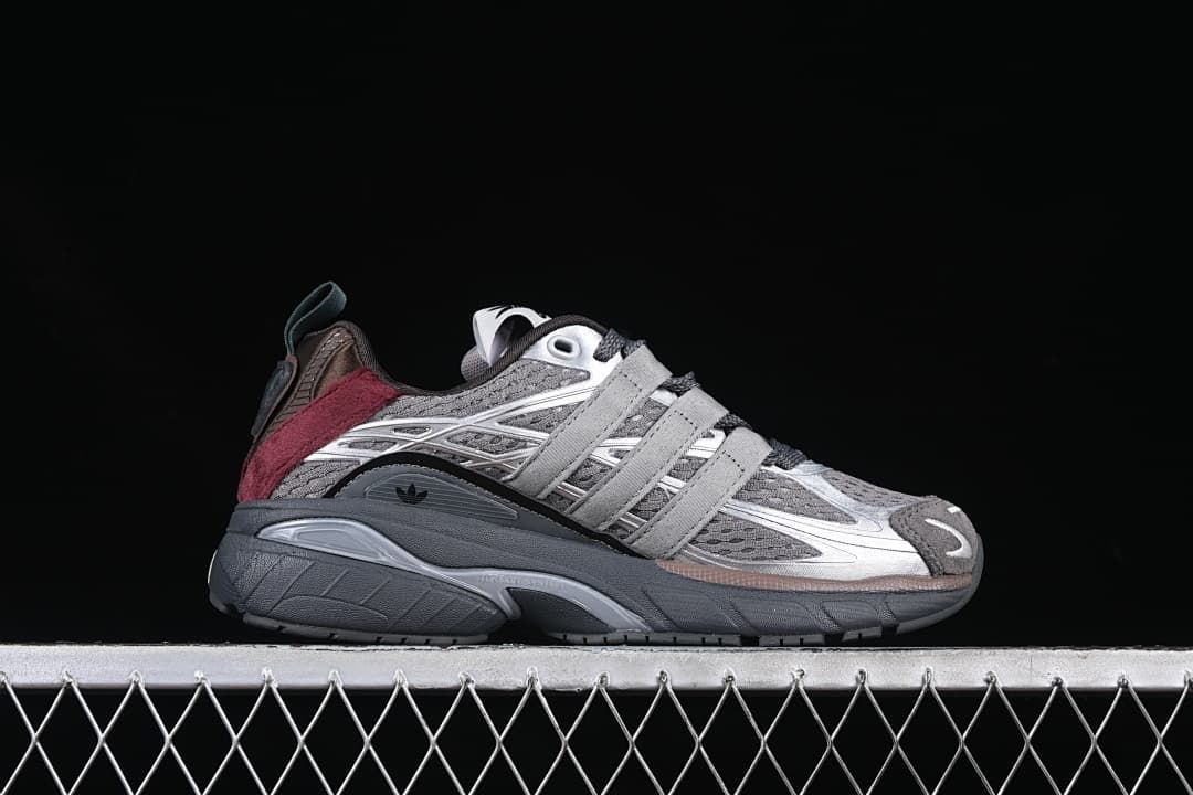 Side profile of one adidas Adistar Cushion sneaker in gray, silver, and burgundy.