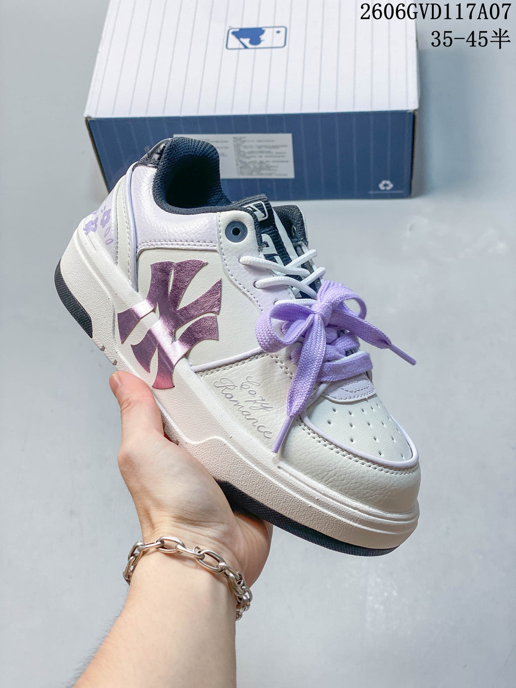 Angled side view of the white MLB sneaker with lavender accents and a dark outsole