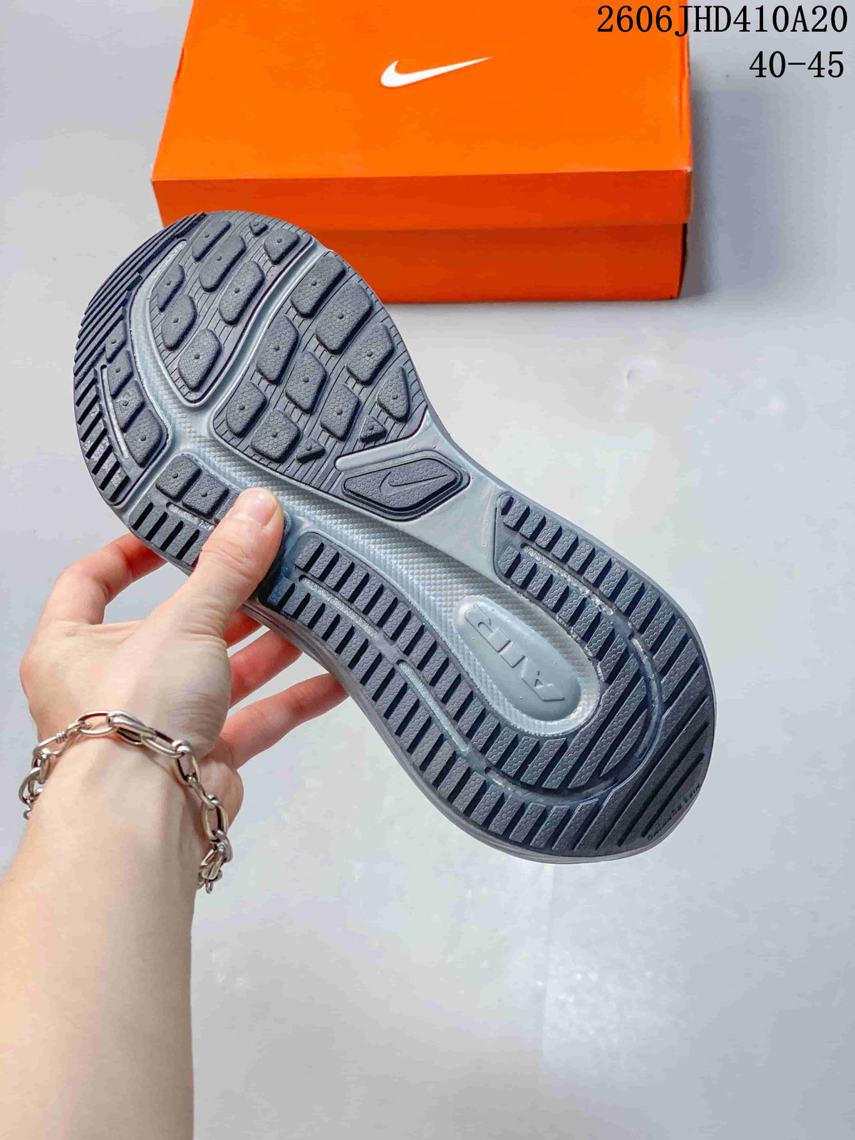 Close-up of the patterned outsole on a dark gray running shoe