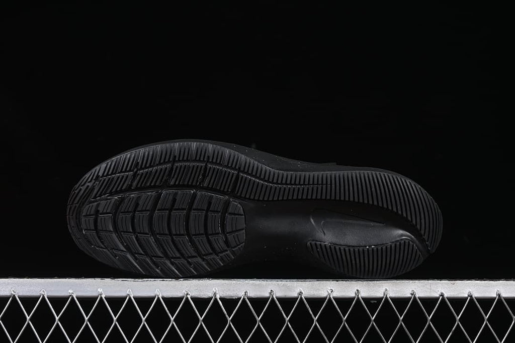 Underside view showing the black patterned outsoles.
