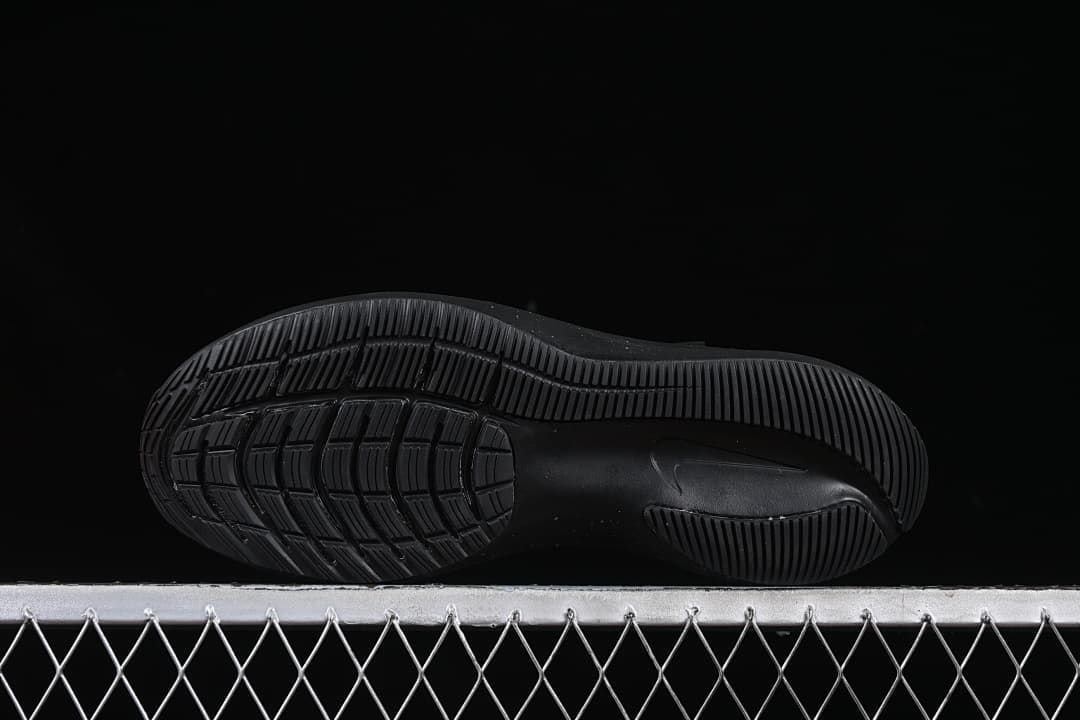 Underside view showing the black patterned outsoles.