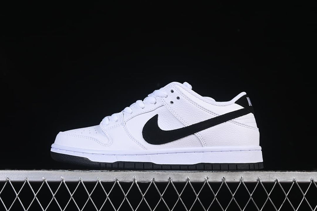 Side profile of the white sneaker with a black Swoosh