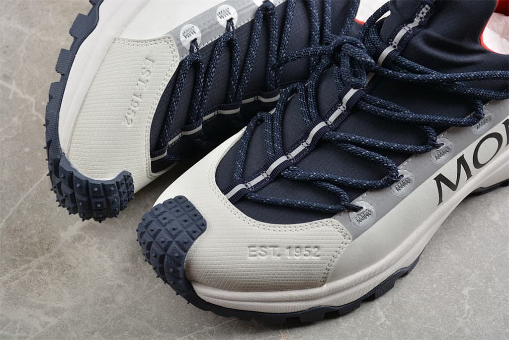 Close-up of the textured toe, lace loops, and rugged outsole of the sneaker.