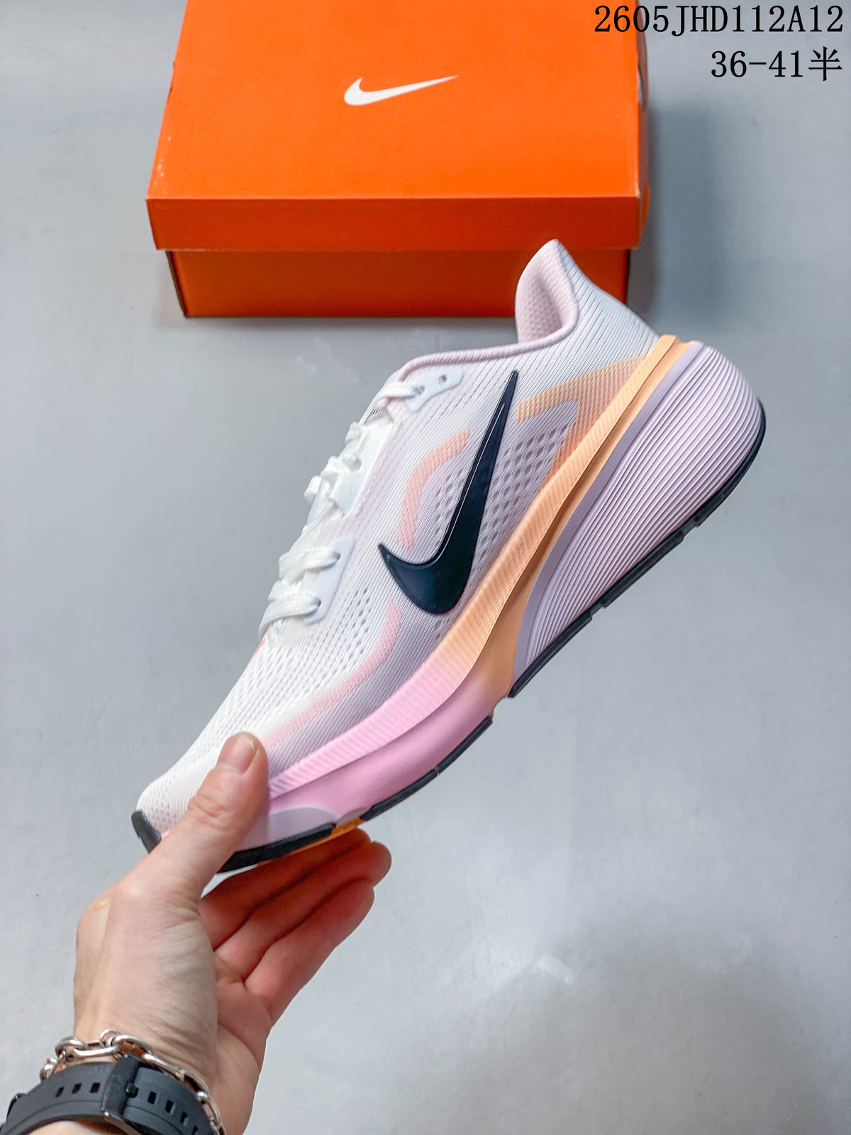 Side view of the white and pink Nike Air Zoom Pegasus 42 running shoe with a dark Swoosh.