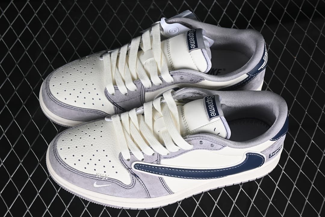 Pair of grey, off-white, and navy low-top sneakers