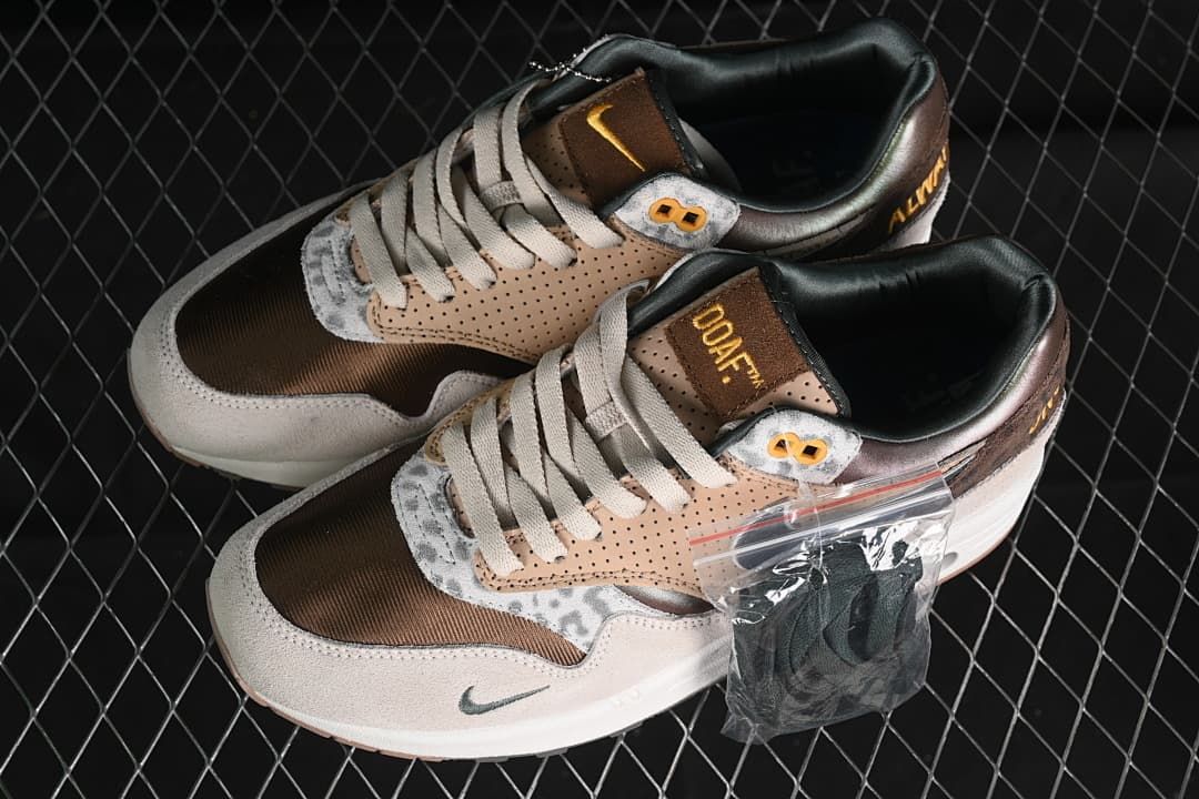 Pair of tan and brown sneakers with an additional dark lace set pictured