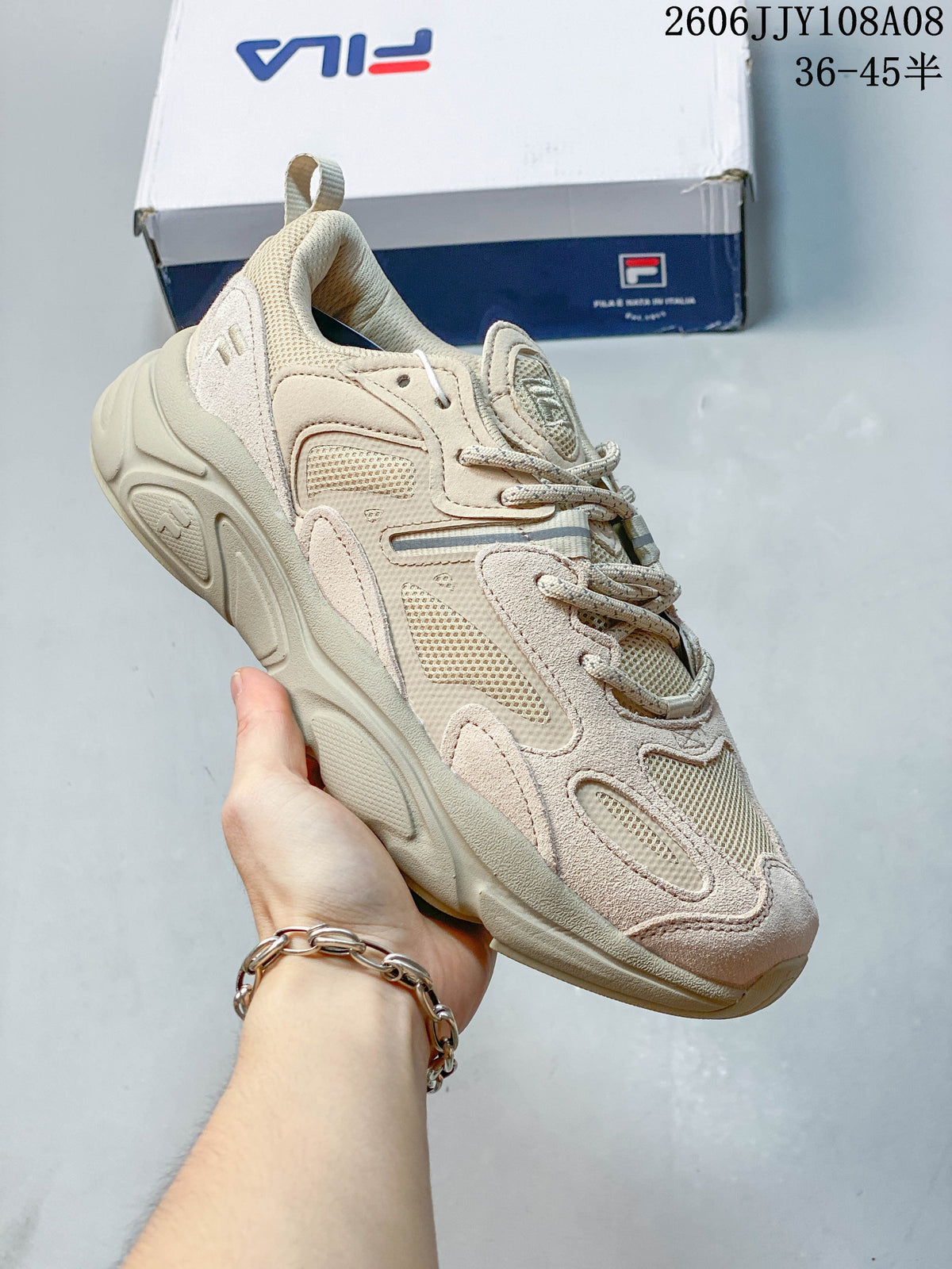 Beige FILA Fusion sneaker with layered detailing and lace-up closure
