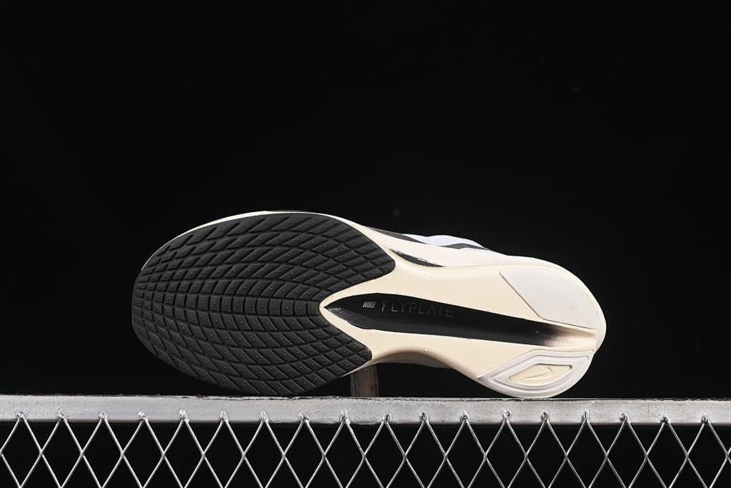 Bottom view of the outsole with dark traction sections and central plate