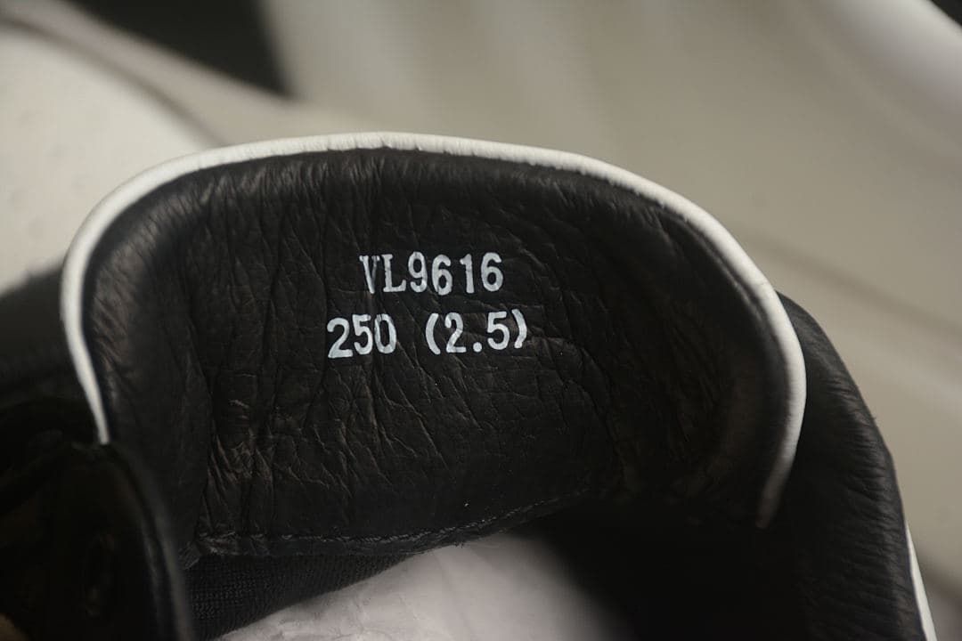 Close-up of the sneaker tongue showing printed size and identification text