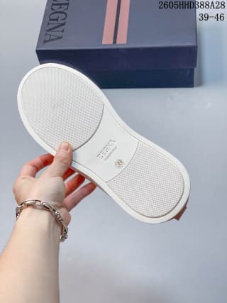 Underside of the white sneaker with a textured rubber outsole.