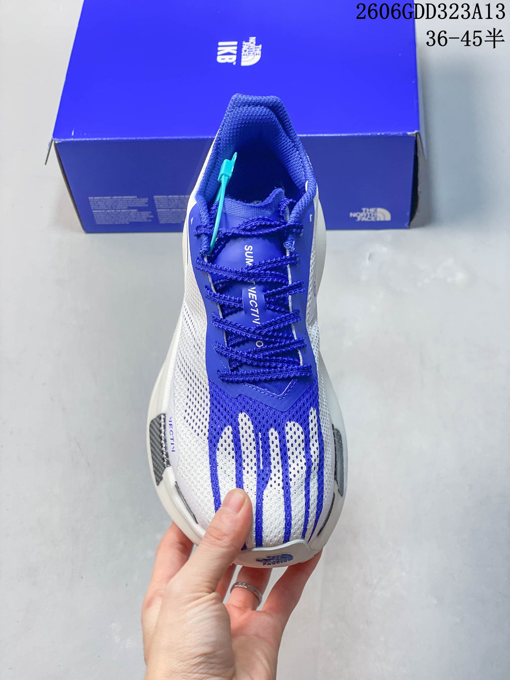 Top view of the shoe showing blue laces and blue-and-white upper