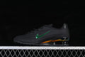 Side view of black Nike Shox Z sneakers with a metallic green Swoosh and iridescent heel detail.