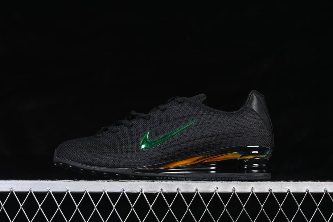 Side view of black Nike Shox Z sneakers with a metallic green Swoosh and iridescent heel detail.