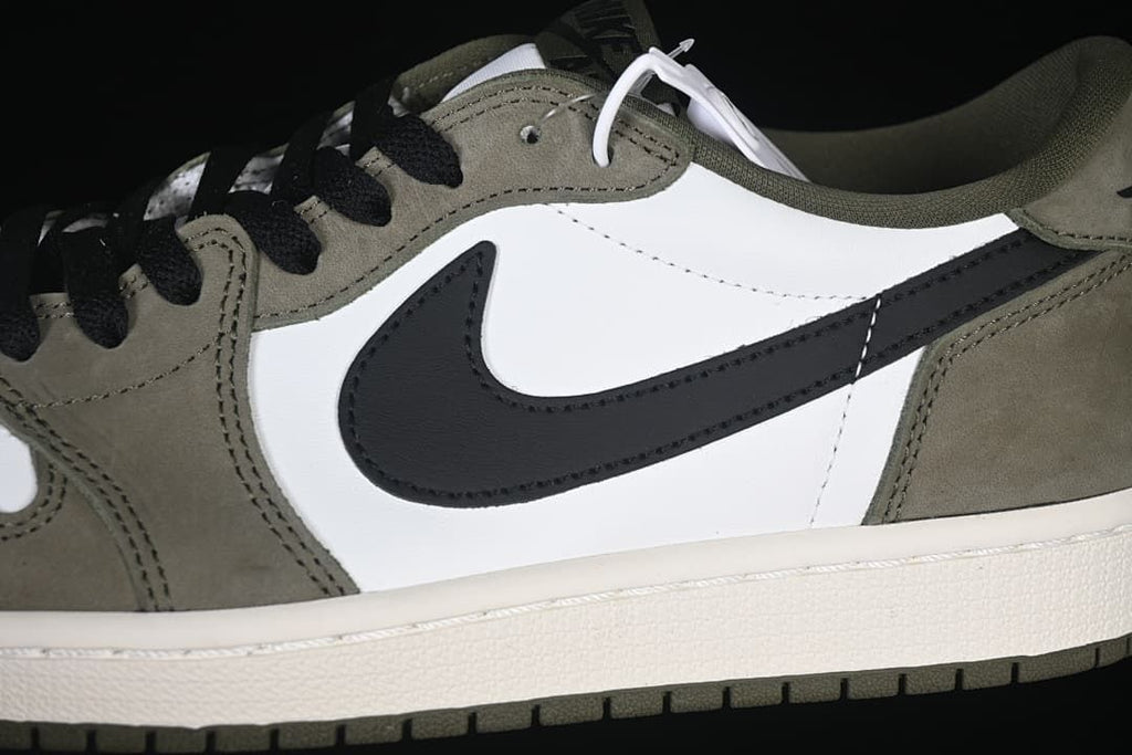 Close-up of the black Swoosh, white side panel, and olive overlays